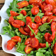 A plate of greens and roasted tomatoes