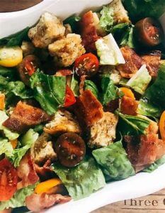 a salad with roasted tomatoes and lemon