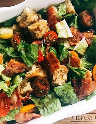 a salad with roasted tomatoes and lemon